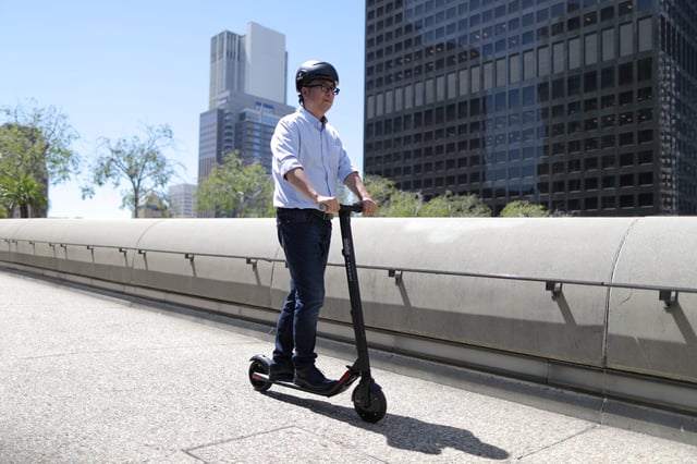 Segway Chairman & CEO Louie Gao rides a scooter in 2018 in Los Angeles.