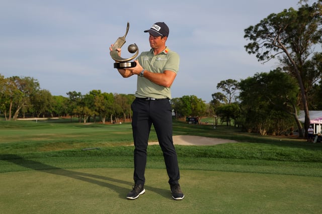 Viktor Hovland of Norway poses with the trophy after putting in to win on the 18th green during the final round of the Valspar Championship 2025 at Innisbrook Resort and Golf Club on March 23, 2025 in Palm Harbor, Florida.