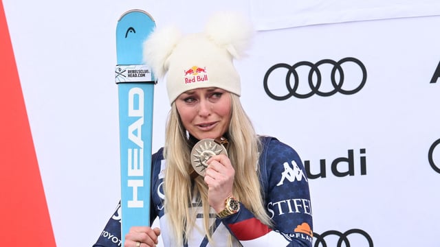 USA's Lindsey Vonn cries on the podium after placing second in the women�s Super-G event at the Audi FIS Ski World Cup Sun Valley Finals in Sun Valley, Idaho, on March 23, 2025. (Photo by Patrick T. Fallon / AFP)