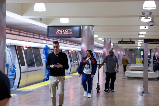 People exit a Bay Area Rapid Transit (BART) train at Powell Street Bart Station on Market Street in San Francisco on Tuesday, April 9, 2024.