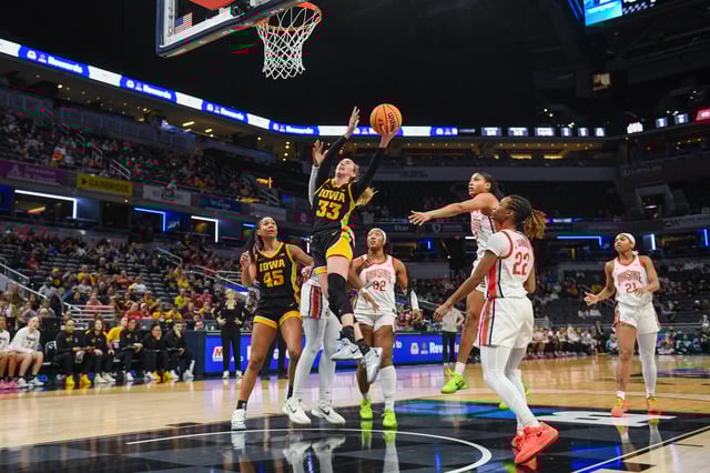 Lucy Olsen #33 of the Iowa Hawkeyes attempts a shot after getting past Cotie McMahon #32, Taylor Thierry #2, and Jaloni Cambridge #22 of the Ohio State Buckeyes during the second half of a Big Ten Women&#39;s Basketball Tournament - Quarterfinals game at Gainbridge Fieldhouse on March 07, 2025 in Indianapolis, Indiana. The Ohio State Buckeyes won the game 60-59.