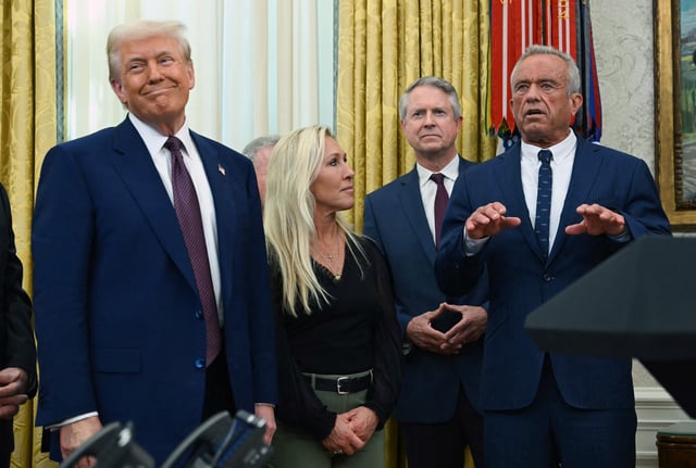 US President Donald Trump (L) and US Representative Marjorie Taylor Greene (2nd L) look on as Robert F. Kennedy Jr. speaks after being sworn in as Secretary of Health and Human Services in the Oval Office of the White House in Washington, DC, on February 13, 2025.