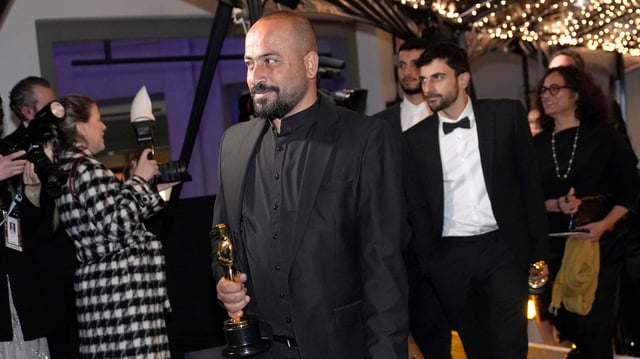 Hamdan Ballal, from left, Yuval Abraham and Basel Adra, winners of the award for best documentary feature film for "No Other Land," attend the Governors Ball after the Oscars on Sunday, March 2, 2025, in Los Angeles. (AP Photo/John Locher)