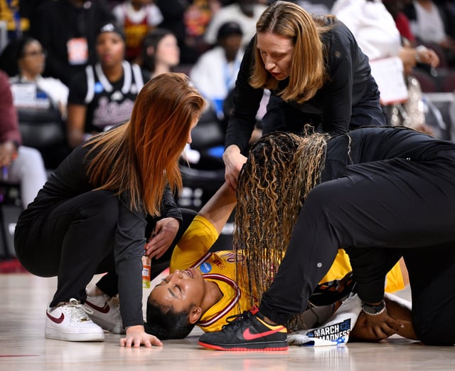 Mar 24, 2025; Los Angeles, California, USA; USC Trojans head coach Lindsay Gottlieb holds USC Trojans guard JuJu Watkins’ hand after she injured her knee in the first quarter of an NCAA Tournament second round game against the Mississippi State Bulldogs at Galen Center. Mandatory Credit: Robert Hanashiro-Imagn Images
