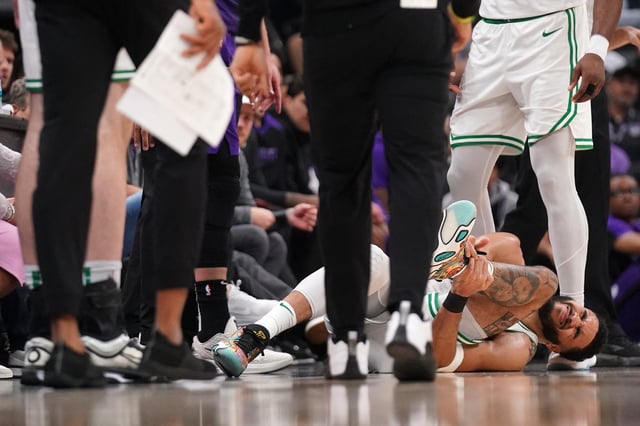 Mar 24, 2025; Sacramento, California, USA; Boston Celtics forward Jayson Tatum (0) lays on the ground after suffering an injury against the Sacramento Kings in the third quarter at the Golden 1 Center. Mandatory Credit: Cary Edmondson-Imagn Images