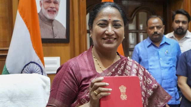 Delhi CM Rekha Gupta shows a folder containing budget papers at her office in Vidhan Sabha ahead of the presentation of the Delhi State Budget in the assembly in New Delhi on Tuesday, 