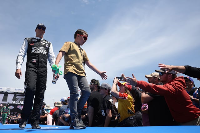 Brexton Busch, son of Kyle Busch, driver of the #8 McLaren Custom Grills Chevrolet, walk the stage prior to the NASCAR Cup Series GEICO 500 at Talladega Superspeedway on April 23, 2023 in Talladega, Alabama.