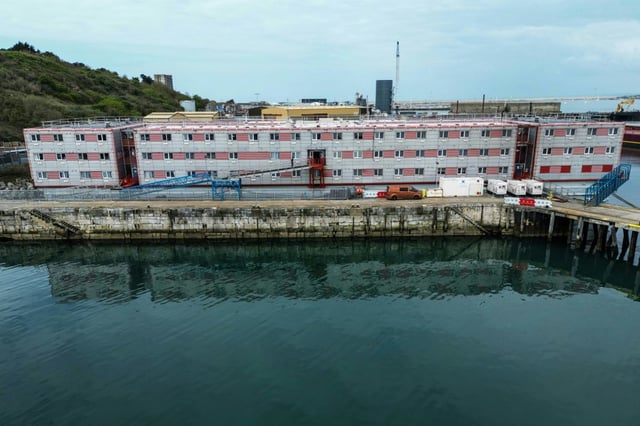 An aerial photograph taken in April 2024 shows the former Bibby Stockholm accommodation barge, moored to the quayside at Portland Port, on the south-west coast of England.