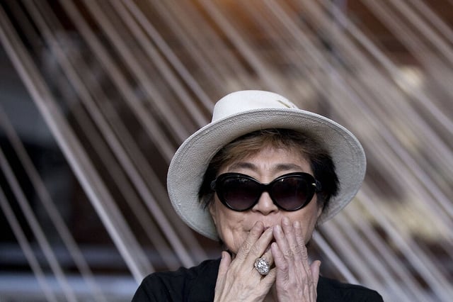 Yoko Ono greets the press at the opening of her exhibition “Land of Hope” at the Museum of Memory and Tolerance in Mexico City in 2016. 