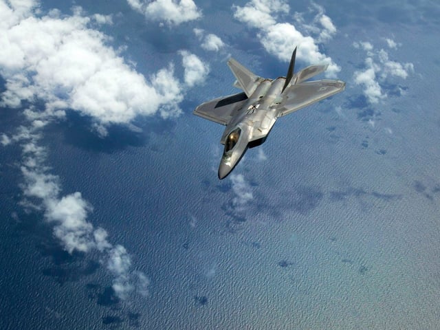 An Air Force F-22 Raptor aircraft banks away after being refueled by a KC-10 Extender aircraft over the Atlantic Ocean, July 15, 2017.