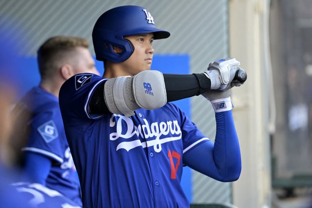 Mar 24, 2025; Anaheim, California, USA;  Los Angeles Dodgers designated hitter Shohei Ohtani (17) gets ready in the dugout during the game against the Los Angeles Angels at Angel Stadium. Mandatory Credit: Jayne Kamin-Oncea-Imagn Images/File Photo