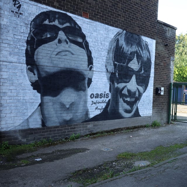FILE PHOTO: A view of a mural of Oasis band members Liam and Noel Gallagher by artist Pic.One.Art on the side of Sifters record shop in the Burnage area of Manchester, Britain, August 31, 2024. REUTERS/Phil Noble/File Photo