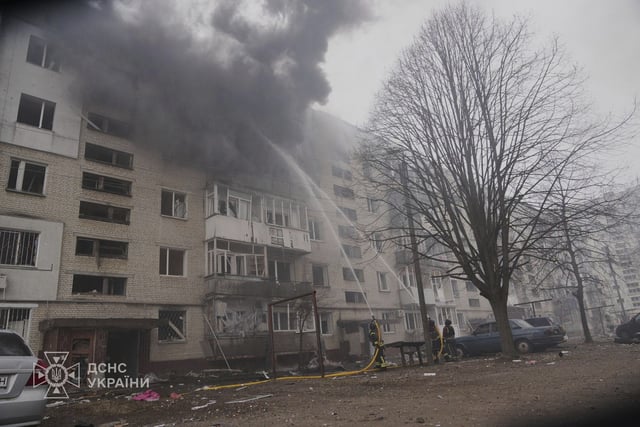 In this photo provided by the Ukrainian Emergency Service, firefighters put out the fire following a Russian attack in Sumy, Ukraine, Tuesday, March 25, 2025.