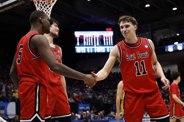 Mar 18, 2025; Dayton, OH, USA; St. Francis (Pa) Red Flash guard Daemar Kelly (5) celebrates a play with guard Riley Parker (11) in the second half against the Alabama State Hornets  at UD Arena. Mandatory Credit: Rick Osentoski-Imagn Images/File Photo