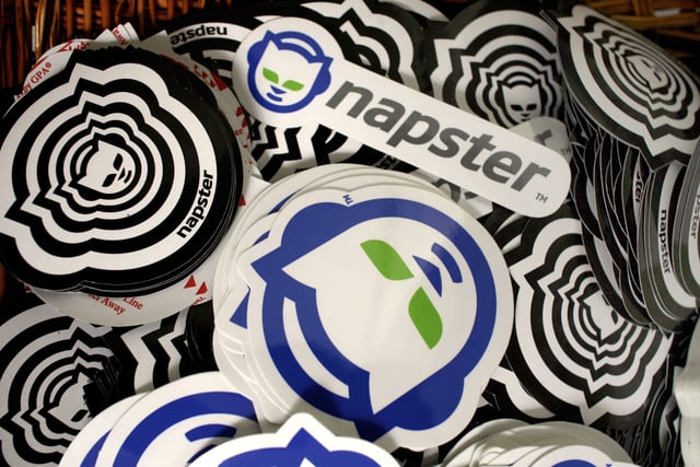FILE- In this Aug. 2, 2006 file photo, promotional Napster stickers are seen at the Napster studio in Los Angeles. (AP Photo/Damian Dovarganes, file)