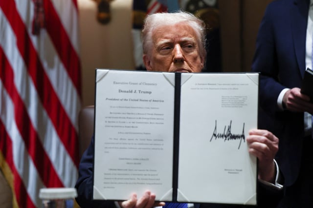 President Donald Trump holds an Executive Grant of Clemency for Devon Archer, at the White House in Washington, D.C., on March 25, 2025.