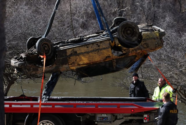The Toyota Celica of Karen Schepers is loaded onto a flatbed truck after being taken out of the Fox River on March 25, 2025, in Elgin. Police later confirmed that human remains had been found inside. (Stacey Wescott/Chicago Tribune)