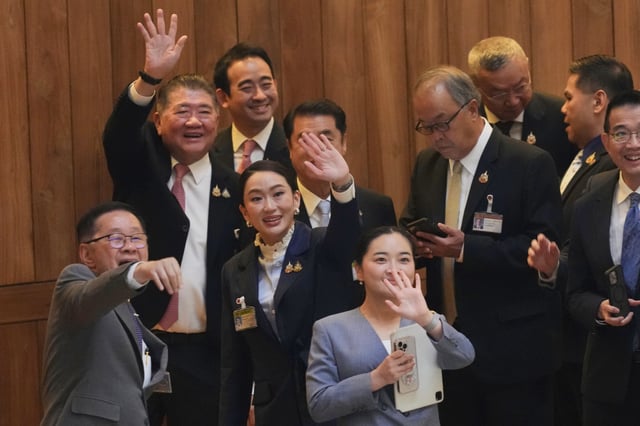Thailand Prime Minister Paetongtarn Shinawatra, third left, reacts after a no-confidence vote against her was defeated in Bangkok, Thailand, Wednesday, March 26, 2025. (AP Photo/Sakchai Lalit)