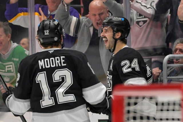 Kings left wing Trevor Moore, left, congratulates center Phillip Danault on his power-play goal during the second period of their game against the New York Rangers on Tuesday night at Crypto.com Arena. (AP Photo/Jayne-Kamin-Oncea)