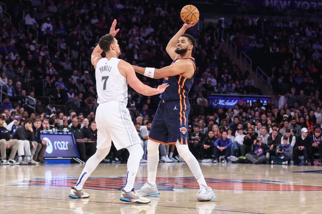 Mar 25, 2025; New York, New York, USA; New York Knicks center Karl-Anthony Towns (32) is guarded by Dallas Mavericks center Dwight Powell (7) in the first quarter at Madison Square Garden. Mandatory Credit: Wendell Cruz-Imagn Images