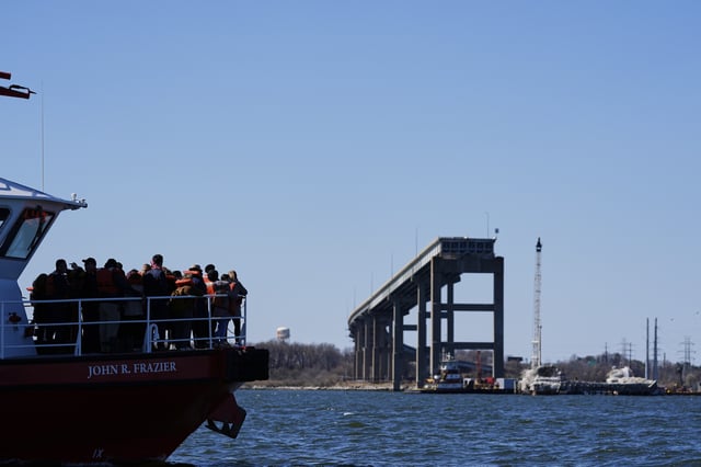 Family members of the workers who died during the collapse of the Francis Scott Key Bridge in Baltimore, among Baltimore Mayor Brandon Scott, Maryland Gov. Wes Moore and other government officials, view the remaining portions of the bridge from a boat in observance of the one-year anniversary of the disaster, Tuesday, March 25, 2025. (AP Photo/Stephanie Scarbrough)