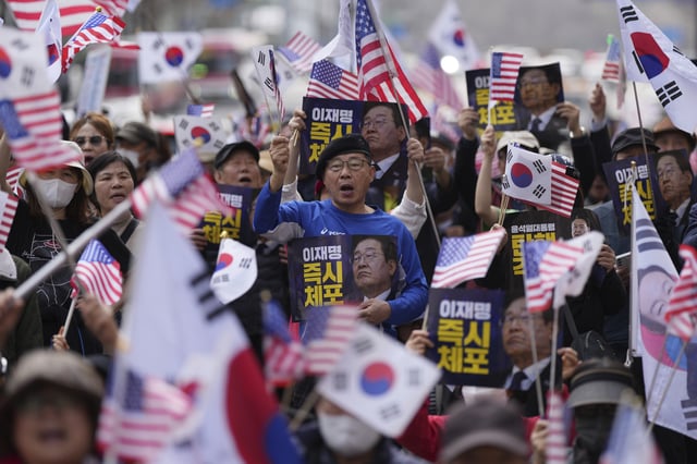 Demonstrators stage a rally demanding the arrest of South Korea's main opposition Democratic Party leader Lee Jae-myung near the Seoul High Court in Seoul, South Korea, Wednesday, March 26, 2025. The letters read, "Immediately arrest Lee Jae-myung." (AP Photo/Lee Jin-man)