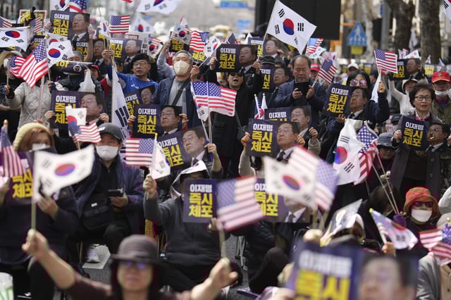 Demonstrators stage a rally demanding the arrest of South Korea's main opposition Democratic Party leader Lee Jae-myung near the Seoul High Court in Seoul, South Korea, Wednesday, March 26, 2025. The letters read, "Immediately arrest Lee Jae-myung." (AP Photo/Lee Jin-man)