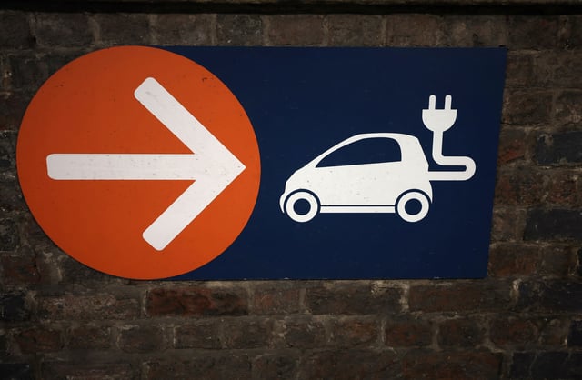 A sign directing towards electric vehicle charging points is seen in a car park in Manchester, Britain, September 8, 2023. REUTERS/Phil Noble/File Photo