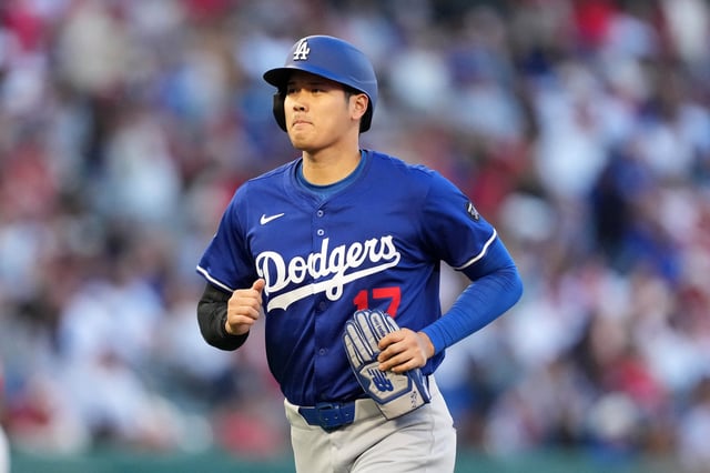 Mar 25, 2025; Anaheim, California, USA; Los Angeles Dodgers designated hitter Shohei Ohtani (17) returns to the dugout after hitting a double in the third inning against the Los Angeles Angels at Angel Stadium. Mandatory Credit: Kirby Lee-Imagn Images/File Photo