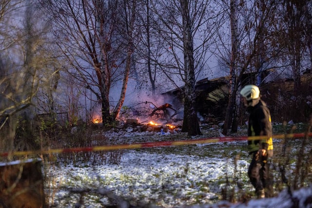 Rescuer walks past DHL cargo plane wreckage, at the crash site near Vilnius International Airport, Lithuania November 25, 2024. Lukas Balandis/BNS via REUTERS/File Photo