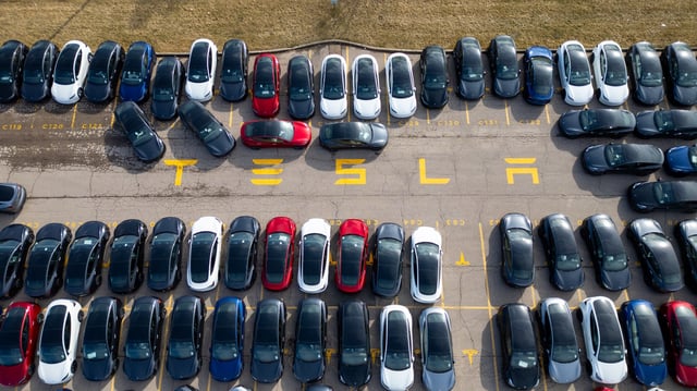 An aerial view of Tesla vehicles sitting in a parking lot on March 20, 2025 in Hamilton, Canada.