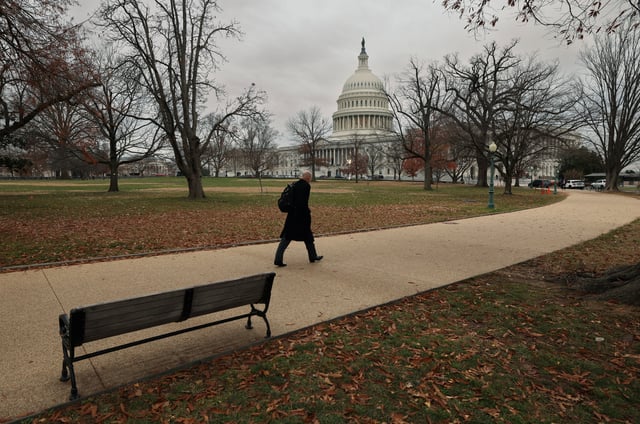 A man walks toward the Capitol on a day where a potential government shutdown looms during the holidays after a spending bill backed by Donald Trump failed in the U.S. House of Representatives, on Capitol Hill in Washington, U.S., December 20, 2024. REUTERS/Kevin Lamarque/File Photo