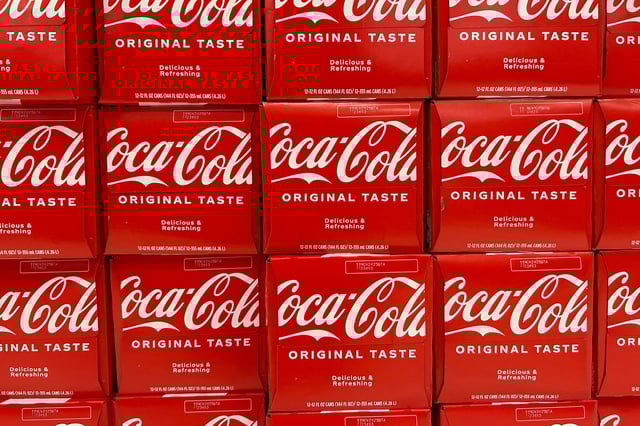 Twelve-pack cases of canned Coca-Cola sit on the shelf at a store in Stevensville, Maryland, on March 25, 2025. Hundreds of Coca-Cola cans in Illinois and Wisconsin have been recalled after reports of plastic being found inside the cans, according to the FDA.