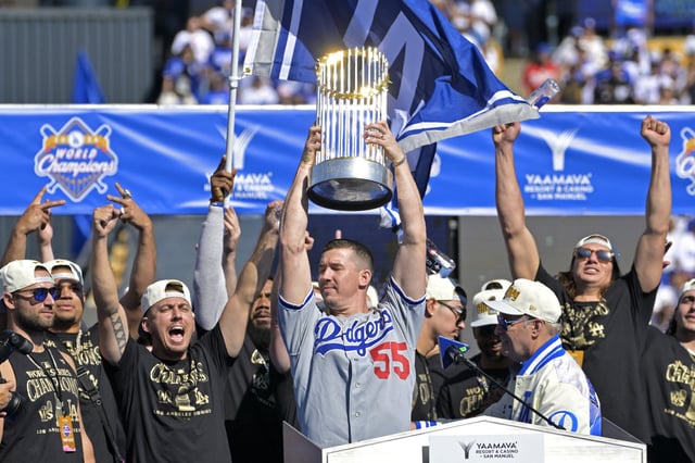 Nov 1, 2024; Los Angeles, CA, USA;  Los Angeles Dodgers starting pitcher Walker Buehler (21) holds the World Series trophy during the team celebration at Dodger Stadium. Mandatory Credit: Jayne Kamin-Oncea-Imagn Images/File Photo