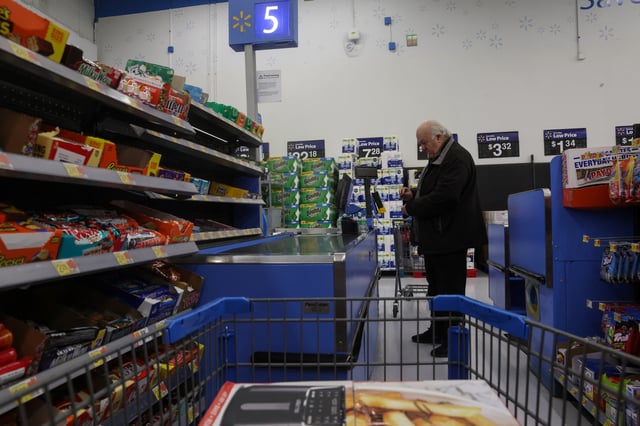 A man pays for a purchase at checkout inside a Walmart department store in Westbury, New York, U.S., November 15, 2023.  REUTERS/Shannon Stapleton/File Photo
