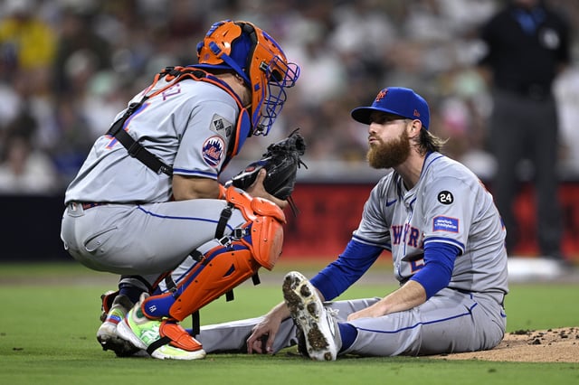 Paul Blackburn #58 of the New York Mets talks with Francisco Alvarez #4 after being hit by a batted ball during the third inning against the San Diego Padres at Petco Park on August 23, 2024 in San Diego, California.