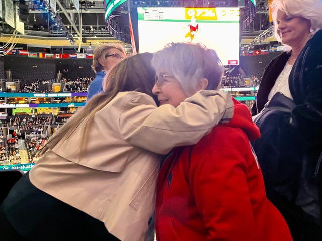 The 1968 Olympic gold medlist Peggy Fleming, left, hugs Janet Champion in Boston during the ISU World Figure Skating Championships at the TD Garden.