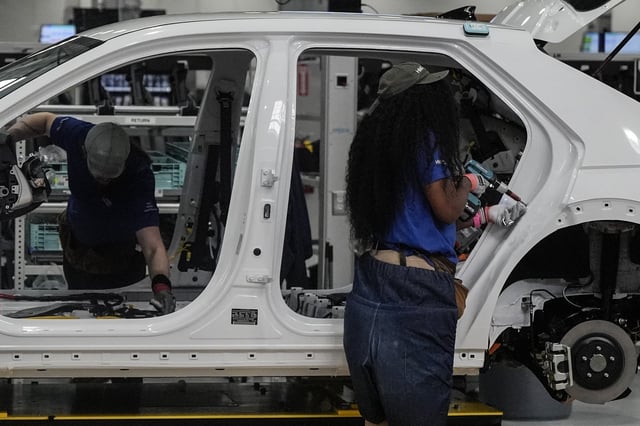 Employees work on the line during a media tour at the Hyundai Motor Group Metaplant America, Wednesday, March 26, 2025, in Ellabell, Ga. (AP Photo/Mike Stewart)