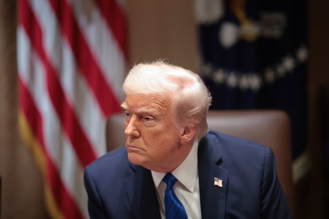 President Donald Trump listens to a reporter&#39;s question during an ambassador meeting at the White House on March 25, 2025.