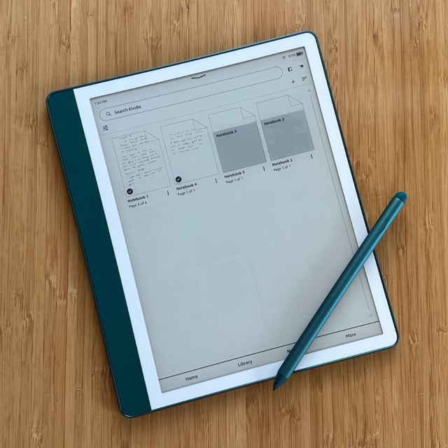 A Kindle Scribe on a wooden table