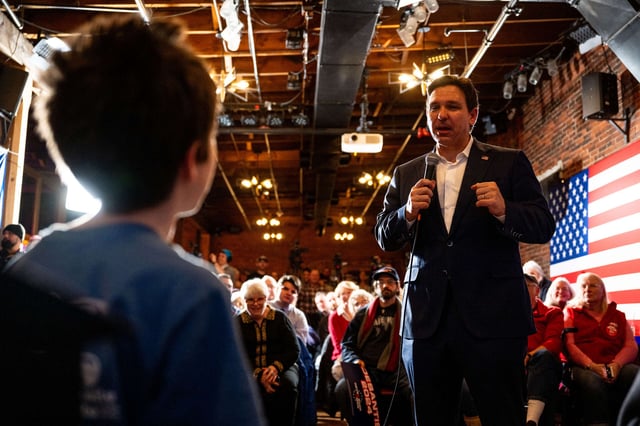 Florida Gov. Ron DeSantis speaks to a child during a campaign rally at the Cara Irish Pub & Restaurant on January 19, 2024, in Dover, New Hampshire.