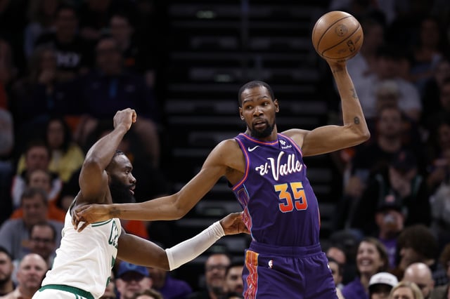 Kevin Durant #35 of the Phoenix Suns posts up on Jaylen Brown #7 of the Boston Celtics during the game at Footprint Center on March 09, 2024 in Phoenix, Arizona. The Celtics defeated the Suns 117-107.