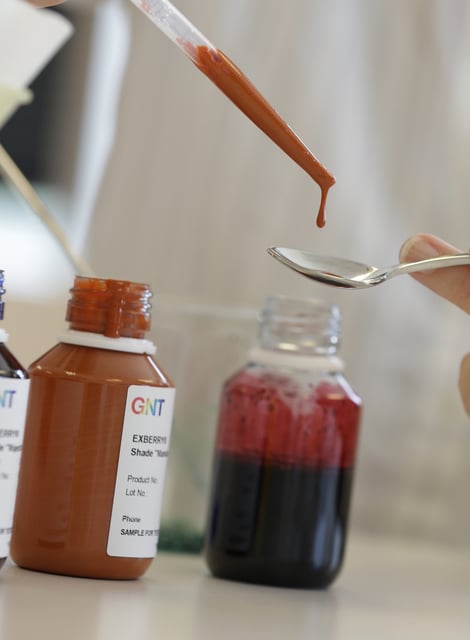 FILE - In this photo from July 29, 2015, a GNT employee deposits carrot extract on to a spoon at their offices in Tarrytown, N.Y. (AP Photo/Seth Wenig, File)