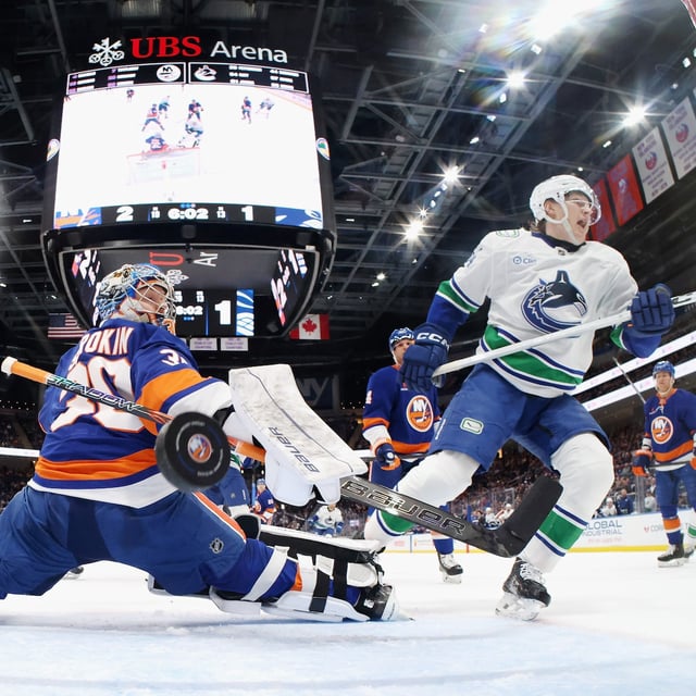 ELMONT, NEW YORK - MARCH 26: Aatu Raty #54 of the Vancouver Canucks scores against Ilya Sorokin #30 of the New York Islanders during the second period at UBS Arena on March 26, 2025 in Elmont, New York. The Canucks defeated the Islanders 5-2. (Photo by Bruce Bennett/Getty Images)