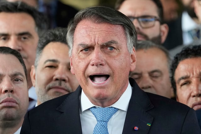 Brazil's former President Jair Bolsonaro speaks to the press at Congress in Brasilia, Brazil, Wednesday, March 26, 2025, after panel of Brazil Supreme Court justices accepted charges against him over an alleged attempt to stay in office after his 2022 election defeat. (AP Photo/Eraldo Peres)