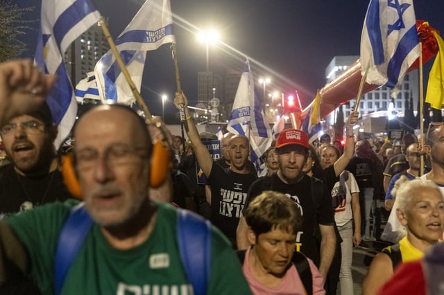Protesters march during a demonstration against controversial legislation that will increase political control over judicial appointments on March 26 in Jerusalem.