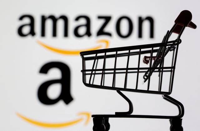 Small toy shopping cart is seen in front of displayed Amazon logo in this illustration taken, July 30, 2021. REUTERS/Dado Ruvic/Illustration/File Photo