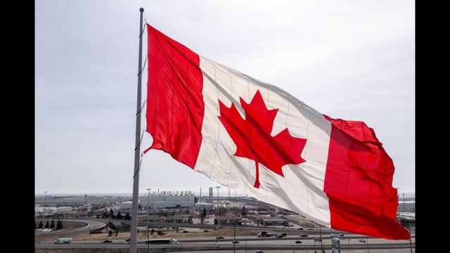 A Canadian flag waves in a plaza near the GM Oshawa Assembly plant in Oshawa, Ontario, Canada. (REUTERS)