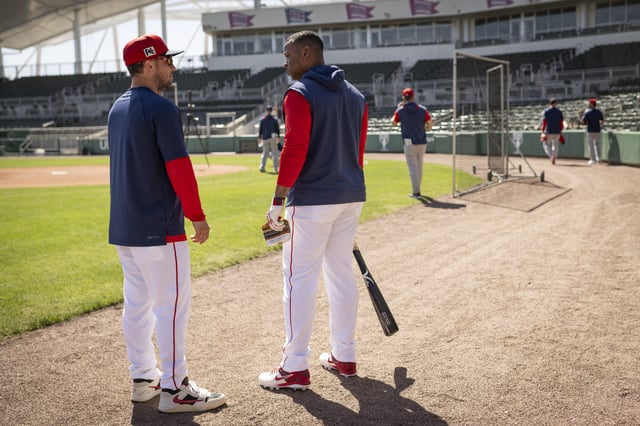 FORT MYERS, FLORIDA - MARCH 6: Alex Bregman #2 of the Boston Red Sox reacts with Rafael Devers #11 of the Boston Red Sox during a Spring Training workout at JetBlue Park at Fenway South in Fort Myers, Florida on March 6, 2025.