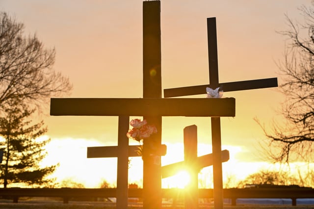 The sun rises illuminating crosses set up at a memorial near Ronald Reagan Washington National Airport on Feb. 2, in Arlington, Virginia, in memory of the victims of a midair collision between an American Airlines flight 5342 and an Army Black Hawk helicopter.